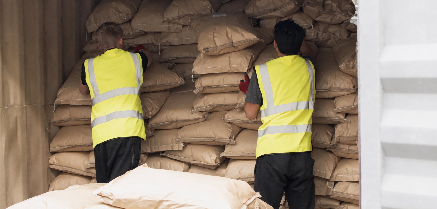 T S Europe staff unloading sacks from a shipping container